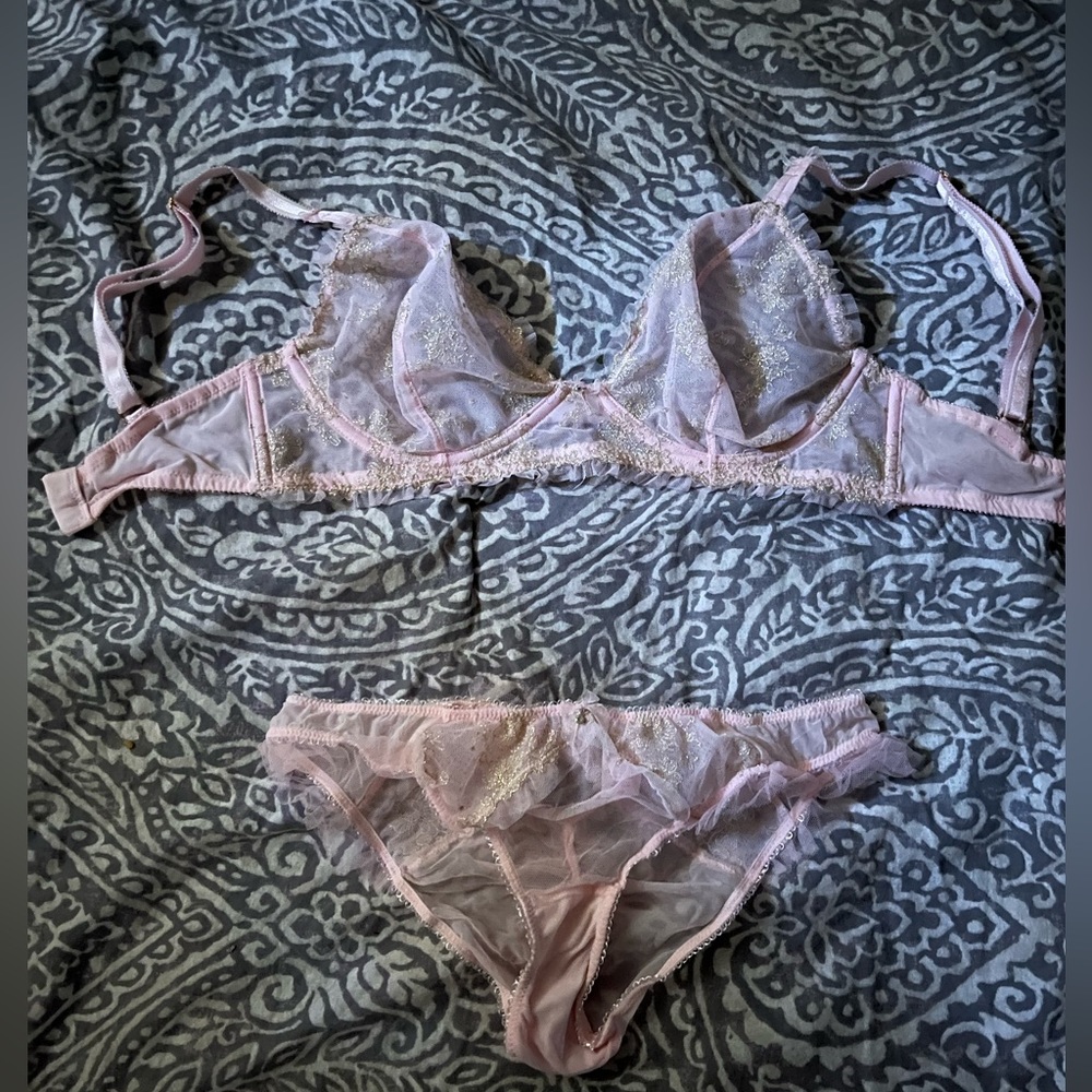 Victoria’s secret baby pink lingerie set with delicate gold detail.